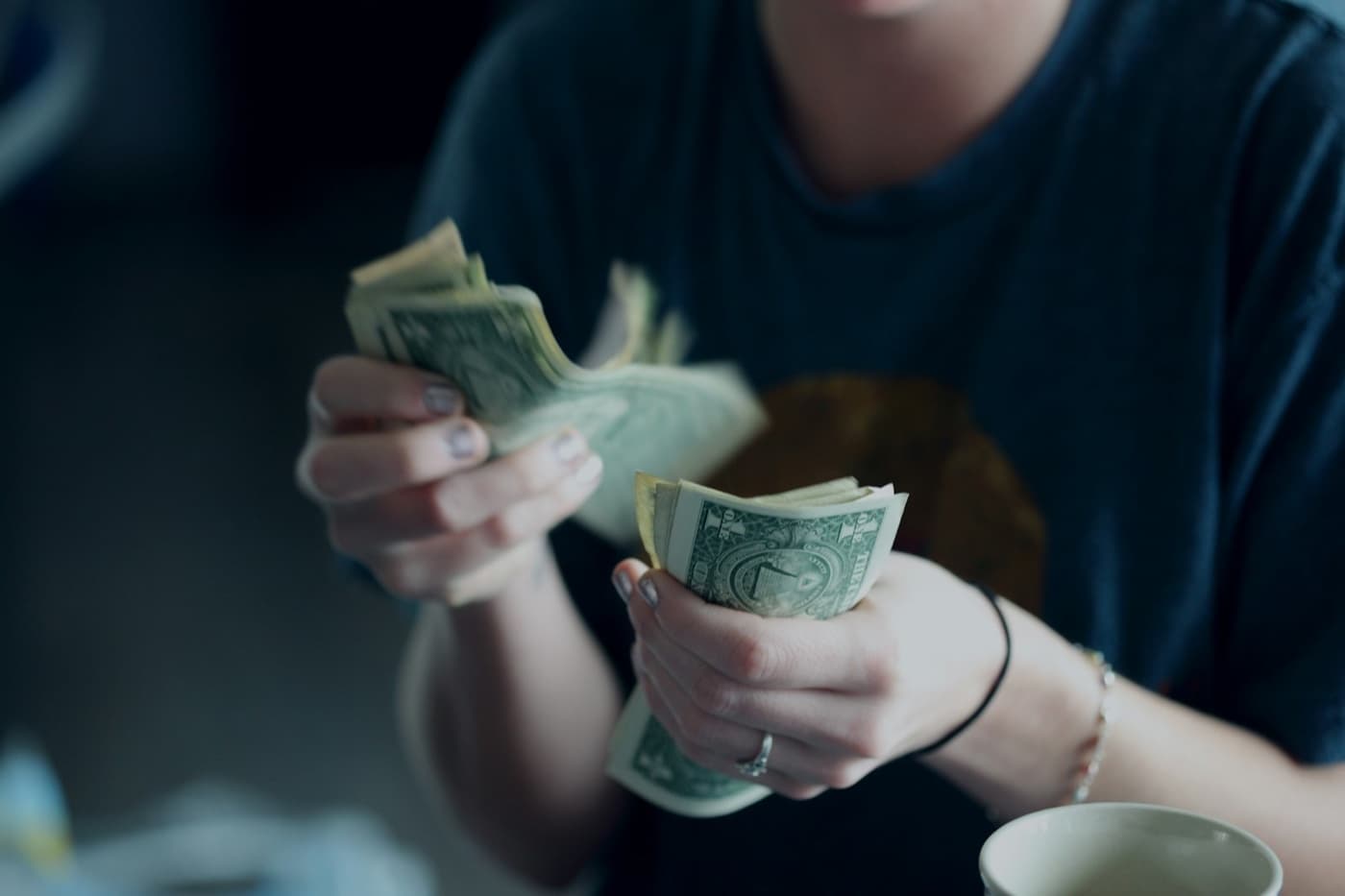 Customer paying with cash at a counter
