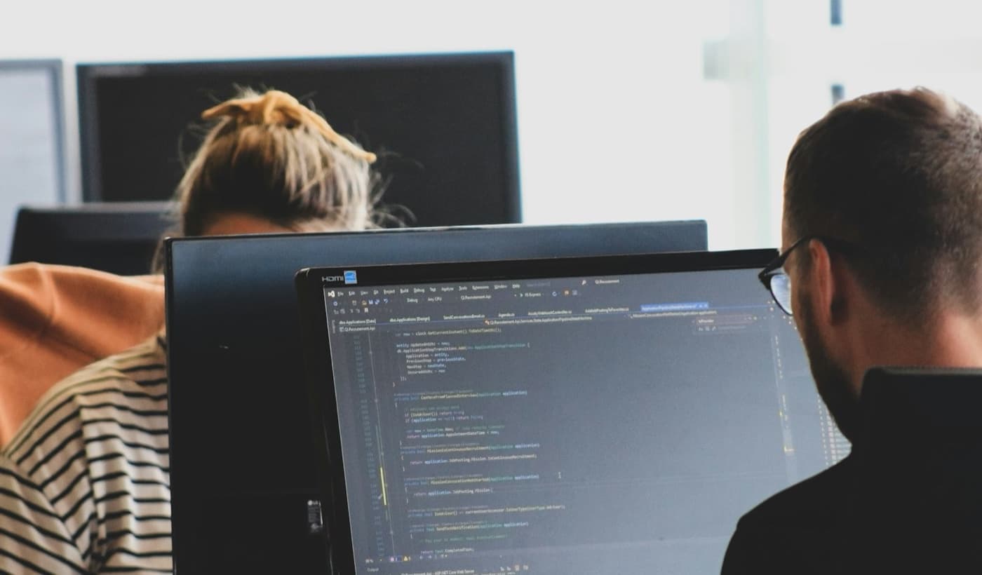 Developer writing code on a laptop