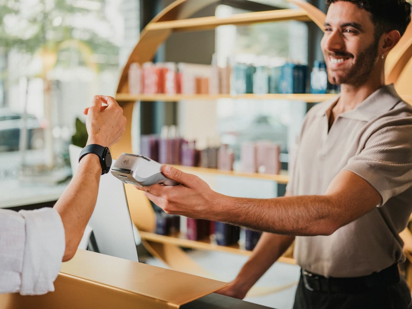 Shop owner taking a card payment at the counter