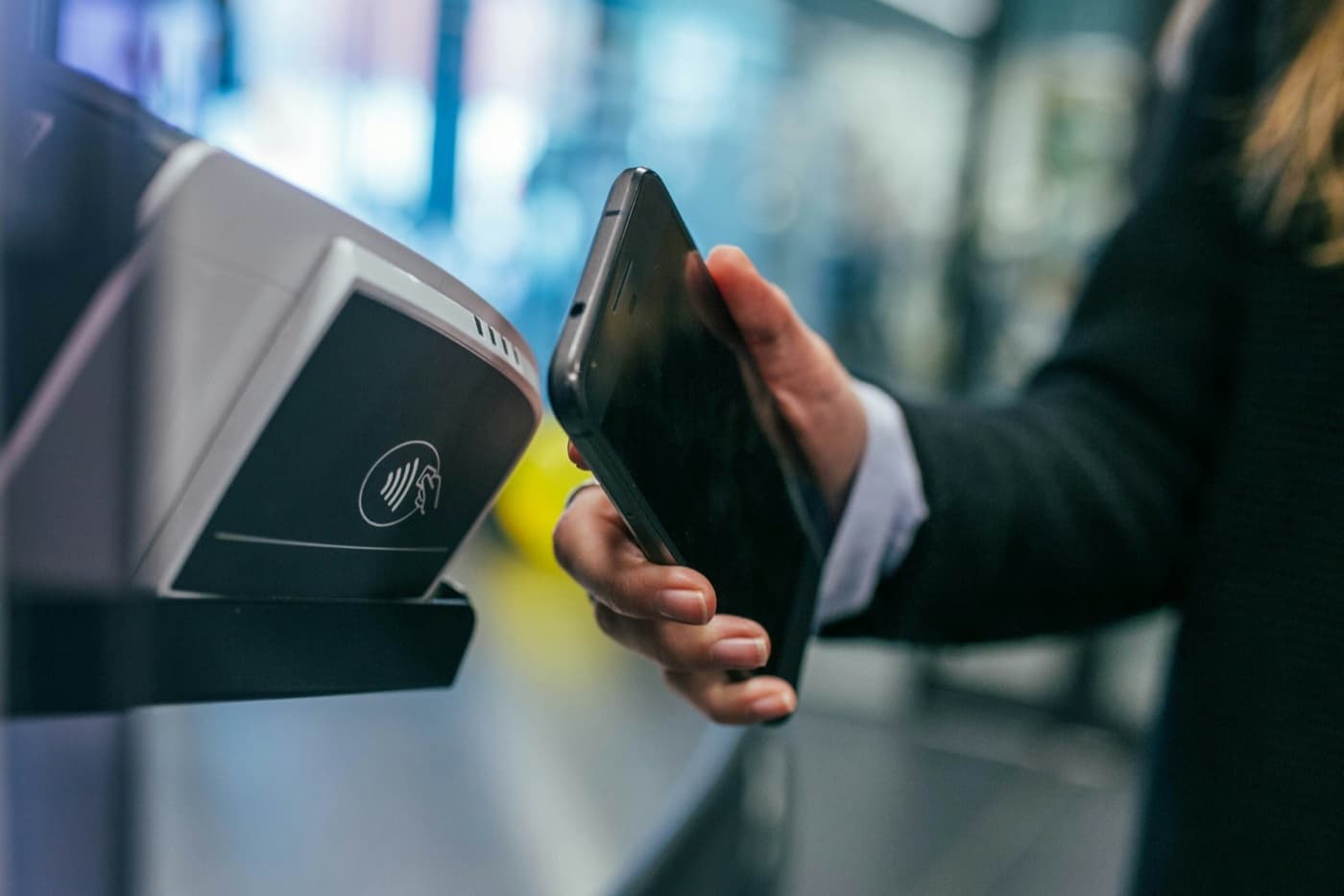 Customer tapping a card on a payment terminal